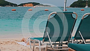 Empty Sun Loungers on the Sandy Beach Against the Turquoise Sea, Albania, Ksamil