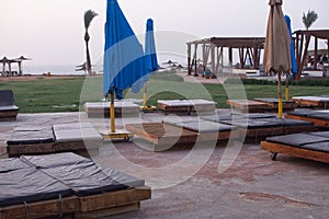 empty sun loungers with a soft surface on the beach.