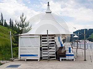 Empty sun loungers stand under a canopy