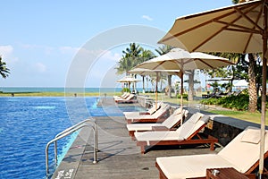 Empty sunbeds by the resort pool