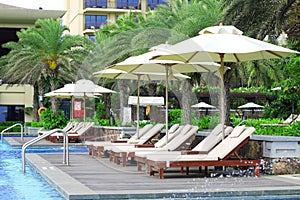 Empty sunbeds by the resort pool