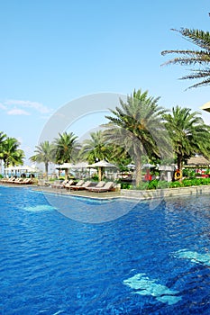 Empty sunbeds by the resort pool