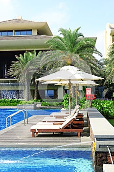 Empty sunbeds by the resort pool