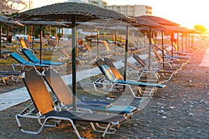 Empty sunbeds in a row on the pebble beach of Europe resirt hotel, Rhodes, Grrece