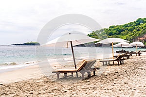 Empty sunbeds waiting for tourists on Virgin beach or Pasir Putih or Perasi Beach on Bali, Indonesia. Beautiful and clean tropical