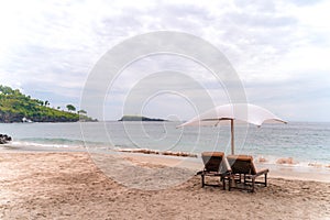 Empty sunbeds waiting for tourists on Virgin beach or Pasir Putih or Perasi Beach on Bali, Indonesia. Beautiful and clean tropical