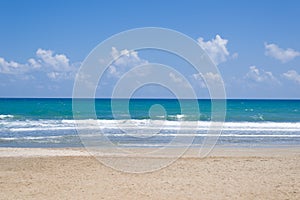 Empty, sunny beach with blue sky