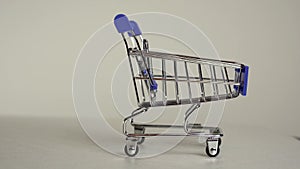 empty supermarket cart close-up on a white background. slow motion