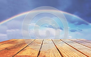 Empty surface of a wooden table on a rainbow background