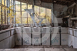 Empty swimming pool in the abandoned school building located in the Chernobyl ghost town