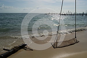 Empty swing on the beach