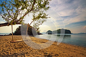 Empty swing at a beach in Thailand at sunset