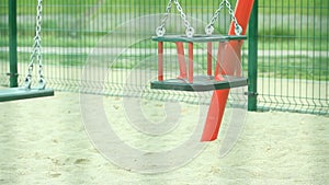 Empty swing on playground.
