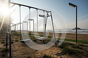 Empty swing at the playground on the beach of Weligama