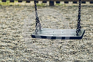 Empty swing on a playground park