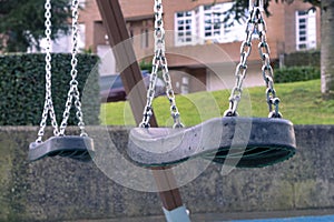 Empty swing on the playground after the rain