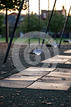 Empty Swing at a Playground at Sunset