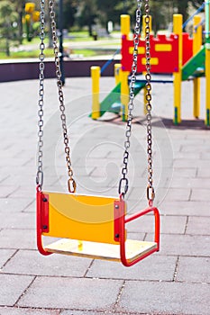 Empty Swing selective focus. Playground for children. Lonly Childhood concept