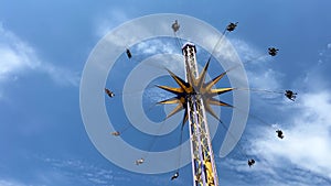 An empty swing is spinning against the background of the sky seating without children is visible Memories of childhood