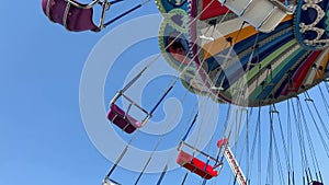 An empty swing is spinning against the background of the sky seating without children is visible Memories of childhood