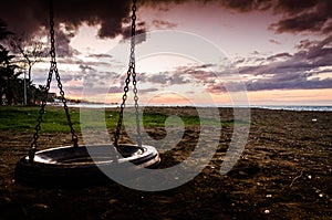 Empty Swing On Sunset In Public Park