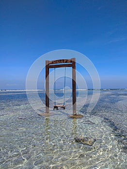 Empty swing at the beach photo