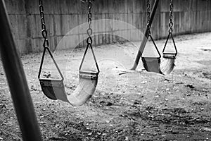 Empty swings in black and white