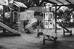 Empty swings on deserted kindergarten playground. Unattended slide and swing set during coronavirus outbreak. Closed for children