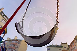 Empty swings on the playground in the courtyard of a residential building in Kyiv, Ukraine