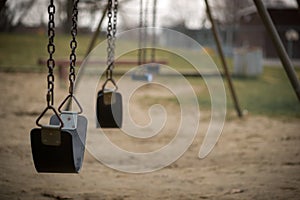 Empty Swings at Playground on Dull Day