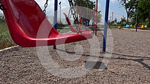 Empty swings swaying at playground