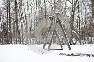 Empty swings from wood in winter