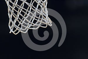 Empty swooshing basketball net close up with dark background. Professional sport concept