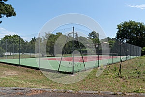 Empty synthetic outdoor green red tennis court