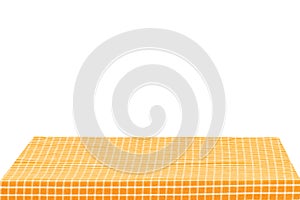 Empty table background. Empty wooden deck table covered with yellow white checkered tablecloth isolated on a white background.
