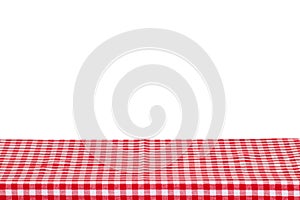 Empty table background. Empty wooden deck table covered with red white checkered tablecloth isolated on a white background. Space