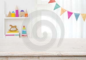 Empty table with blurred children toy shelf and window background