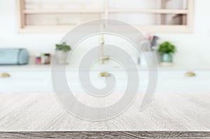 empty table board and defocused modern kitchen background. product display concept