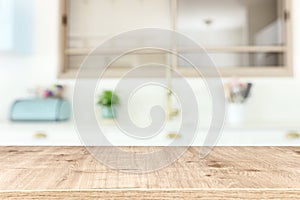 empty table board and defocused modern kitchen background. product display concept