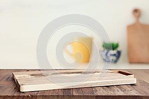 empty table board and defocused modern kitchen background. product display concept