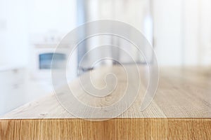 Empty table board and defocused modern kitchen background. product display and picnic concept