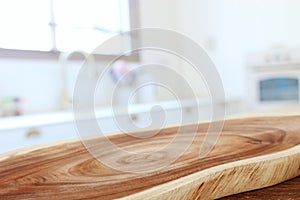 Empty table board and defocused modern kitchen background. product display and picnic concept