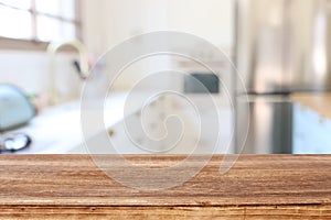 Empty table board and defocused modern kitchen background. product display and picnic concept