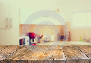 Empty table board and defocused white retro kitchen background