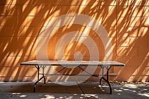 Empty table on bright brown wall background