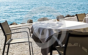Empty table in a cafe on the shore of the sea or lake