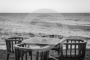 Empty table and chairs in a cafe by the sea