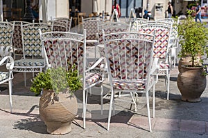 Empty table and chairs in restaurant, Greece. Beach cafe near sea, outdoors. Travel and vacation concept