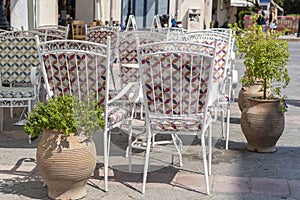 Empty table and chairs in restaurant, Greece. Beach cafe near sea, outdoors. Travel and vacation concept