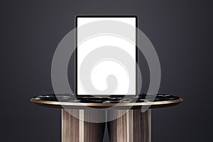 Empty table with empty white mock up tablet on black background. 3D Rendering